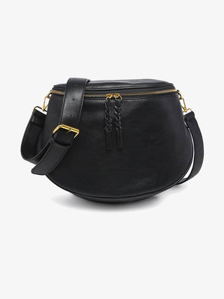 Black leather half-moon crossbody bag with gold zipper and adjustable strap.
