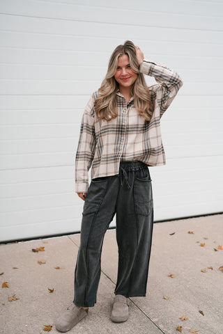 Full-length view of the Tessa plaid button down top styled with wide leg pants
