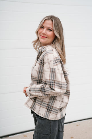Side view of the khaki plaid button down shirt showing the drop shoulder and cropped length