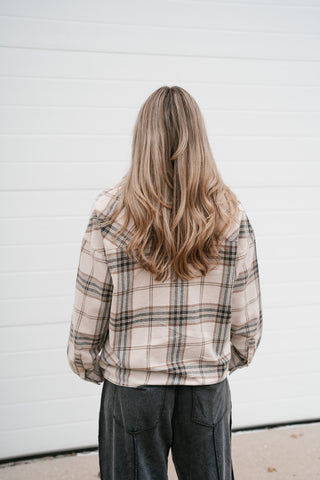 Back view of the boxy khaki and black plaid long sleeve button down top