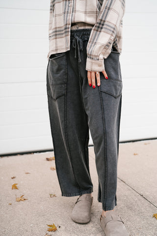 Angled view of the black mineral wash utility pants with drawstring waist and relaxed leg
