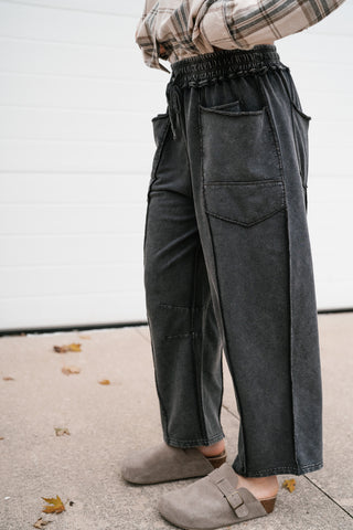 Side view of the Next Stop utility pants showing the side patch pocket and curved barrel leg