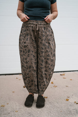 Front view of the relaxed mocha floral pants showing the curved barrel leg and cropped length