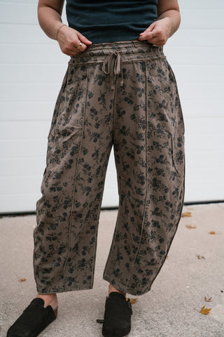Close-up of the mocha floral print, drawstring waist and exposed front seams on the Maisie barrel pants