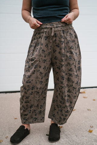Front view of the relaxed brown floral pants showing the roomy barrel leg shape