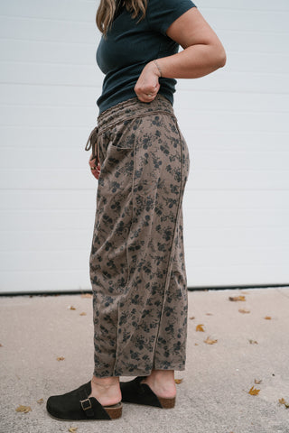 Side view of the mocha floral barrel leg pants showing the cropped length and relaxed fit