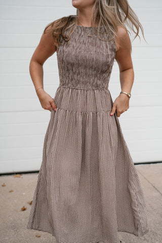 Front view of the sleeveless brown gingham midi dress with fitted smocked top