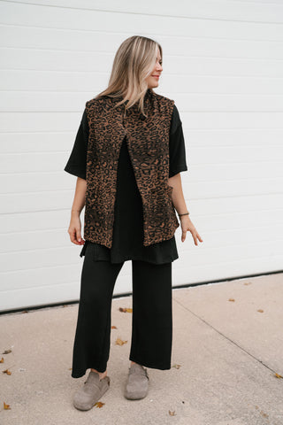 Front view of the women's leopard print vest showing the curved split hem and relaxed hip-length fit
