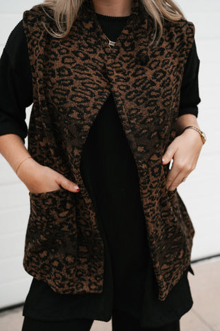 Close-up of the leopard print vest's single button at the neckline and overlapping front