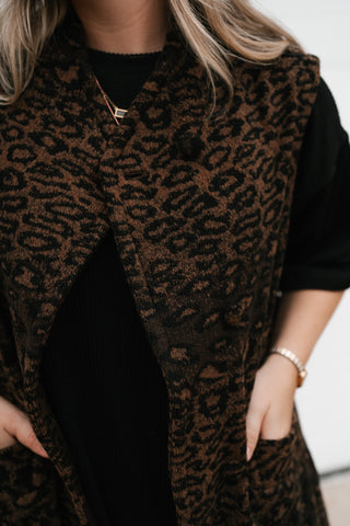 Detail of the brown and black leopard print texture and front button on the Out of Office vest