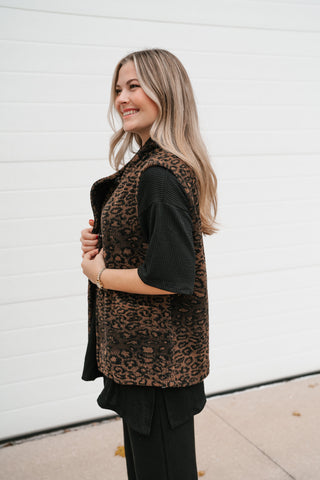 Side view of the relaxed leopard print vest showing the sleeveless armhole and hip length