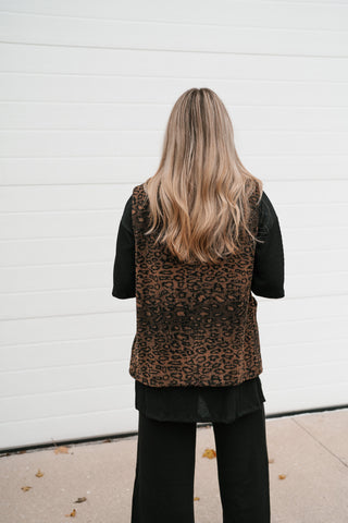 Back view of the brown and black leopard print puffer vest