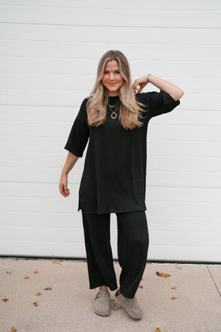 Woman wearing the Always Cozy black ribbed oversized top with the matching wide leg pants
