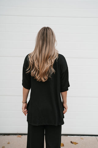 Back view of the Always Cozy black ribbed oversized top with dolman sleeves