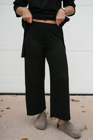Black ribbed cropped wide leg pants styled with the matching oversized top and clogs