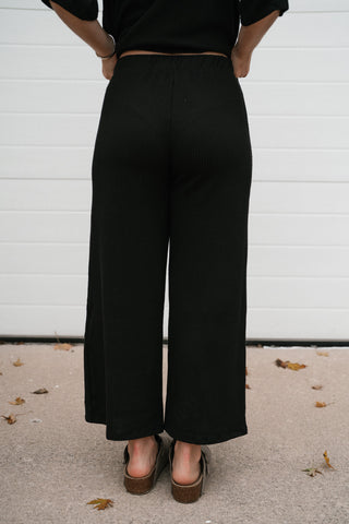 Back view of the Always Cozy black ribbed wide leg lounge pants
