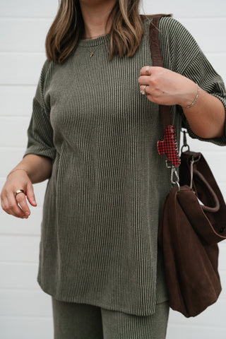 Close-up of the olive ribbed set top's drop shoulder sleeve and soft ribbed knit