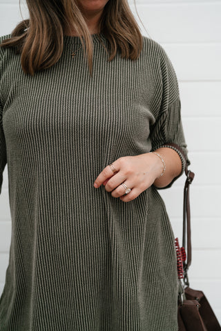 Close-up of the olive ribbed knit texture and crew neckline on the Everyday Olive set top