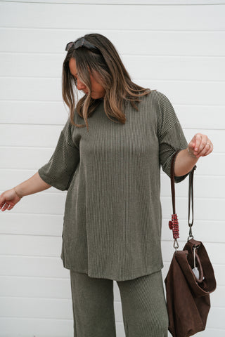 Front view of the relaxed olive ribbed top worn with the matching ribbed pants
