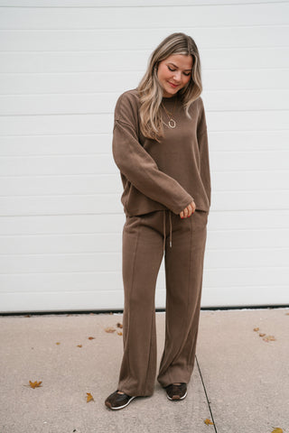 Full-length front view of the brown ribbed crewneck top and matching pants lounge set