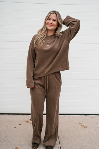Woman wearing the All Day Comfort mocha ribbed crewneck top with the matching wide leg lounge pants