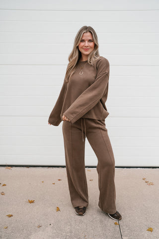 Full-length view of the brown matching lounge set with relaxed crewneck top and wide leg pants