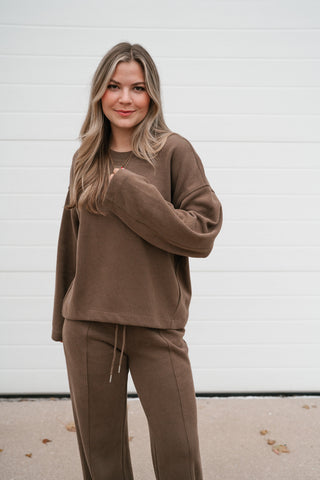 Waist-up view of the relaxed mocha ribbed crewneck top worn with the matching lounge pants