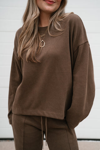 Close-up front view of the mocha ribbed crewneck top showing the crew neckline and relaxed body