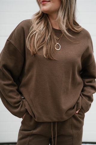 Close-up of the mocha ribbed crewneck top showing the relaxed fit, drop shoulders and soft knit
