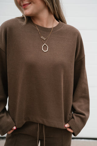 Close-up of the mocha ribbed knit texture and crew neckline on the All Day Comfort top