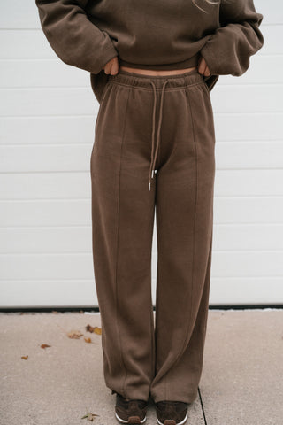 Front view of the mocha drawstring lounge pants with center front seam detail and full-length wide leg