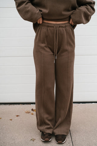 Close-up front view of the brown ribbed knit lounge pants with elastic drawstring waistband