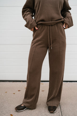 Mocha ribbed wide leg pants worn as a matching lounge set with the mocha crewneck top and sneakers