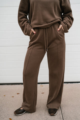 Model with hands in the pockets of the mocha ribbed lounge pants from the All Day Comfort set