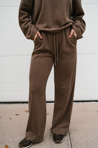 Mocha ribbed wide leg lounge pants styled with the matching top and dark sneakers