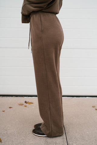 Side view of the mocha ribbed wide leg lounge pants showing the relaxed fit and drawstring