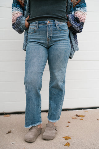 Front view of the medium blue wash straight leg jeans showing the side seam detail and ankle length