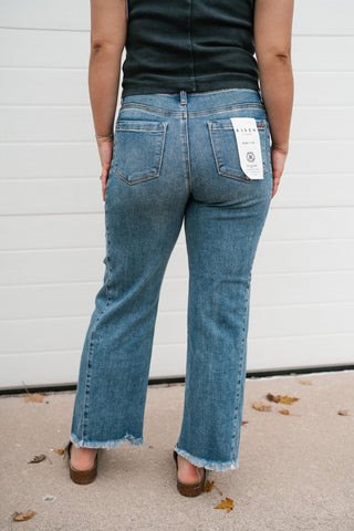 Back view of the medium wash high rise ankle straight jeans showing the back pockets