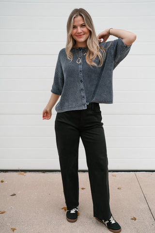 Smiling model in the Better Days navy cotton cardigan showing the relaxed boxy fit