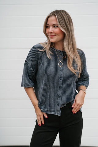 Three-quarter view of the Better Days navy knit cardigan showing the drop shoulder and short sleeve