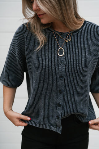 Close-up front view of the navy button front sweater showing the faded ribbed texture