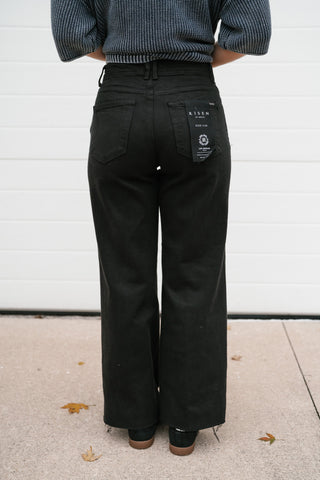 Back view of the Risen Parker black high rise wide leg jeans showing the back pockets