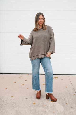Full-length front view of the oversized brown lightweight sweater with jeans and clogs