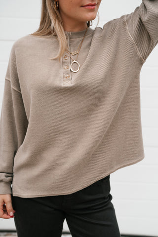 Close-up of the mocha waffle knit texture and button-front henley neckline