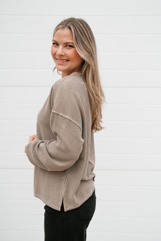 Side view of the mocha thermal long sleeve top showing the side slit and drop shoulder