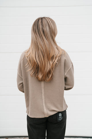 Back view of the mocha thermal henley top showing the exposed center back seam and patch detail