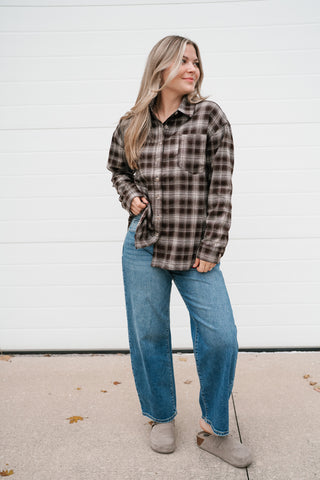 Front view of the relaxed brown plaid button up shirt with chest pocket and wide leg jeans