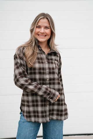 Smiling model wearing the Maren brown plaid collared button down top