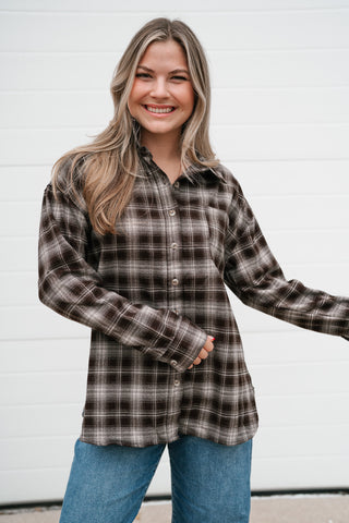 Model in the brown and cream plaid long sleeve shirt with chest pocket and drop shoulders