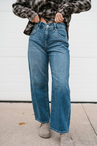 Front view of the Risen Peyton barrel jeans with light fading and a cropped hem